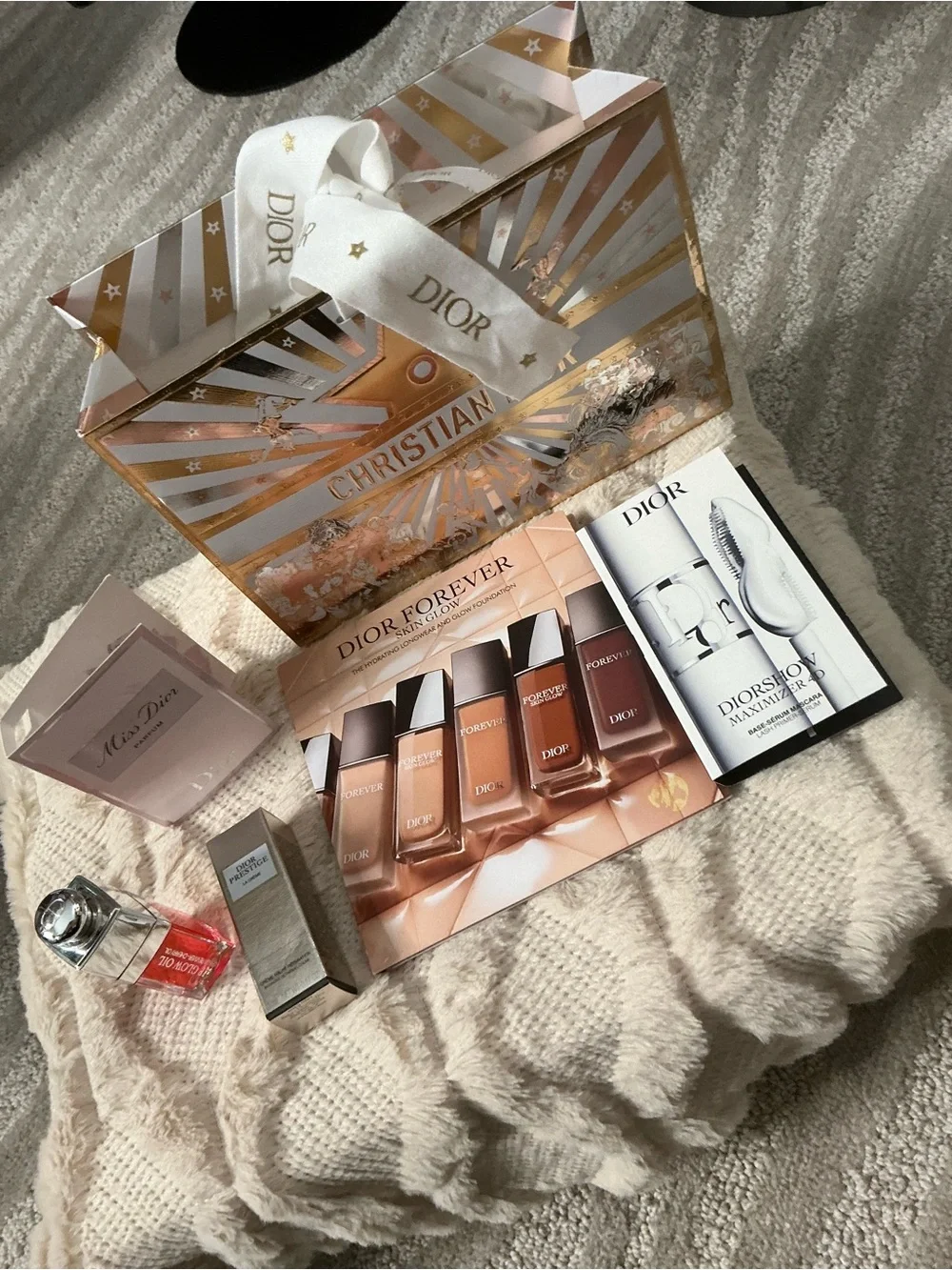Dior gift package with gold & white festive bag and neutral samples